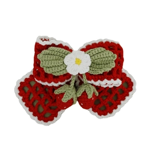 Handmade crochet hair clip with a red bow, white lace trim and strawberry pendants