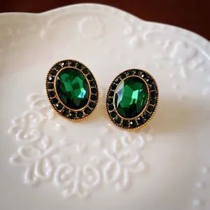 Vintage emerald green oval stud earrings with gold plating and sparkling crystals