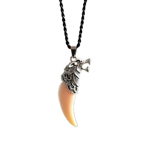 Detail of vintage wolf head pendant necklace with resin fang and black woven cord