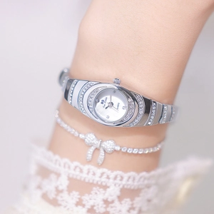 Close-up of elegant silver quartz watch with pavé zircon setting and matching bracelet