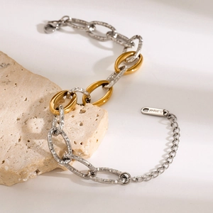 Detailed macro of two-tone stainless steel chain bracelet with textured silver links