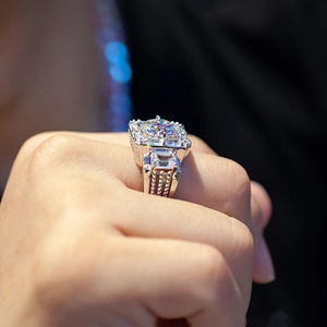 Close-up of luxury men's ring with large square zircon and intricate side diamond setting