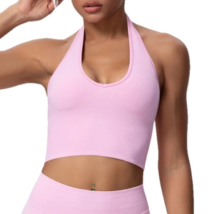 Pink seamless halter neck sports bra with ribbed texture for yoga and fitness training