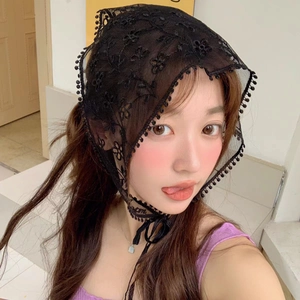Detail of black floral lace headscarf with hollow-out pattern on female model