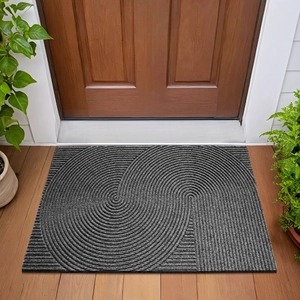 Gray rectangular entrance mat with swirl texture placed in front of a wooden door