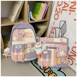 Detail of purple and pink nylon school bag set with cute charms and functional pockets