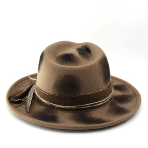 Detail view of khaki fedora with vintage burnt effect, decorative rope and feather accent