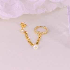 Detailed macro view of S925 silver gold tassel earring with white pearl and zircon