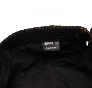 Detail view of the black twill lining and care label inside the tie-dye knit ivy cap