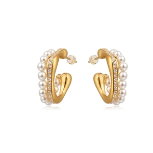 Elegant C-shaped gold earrings featuring layered rhinestones and pearls on white background