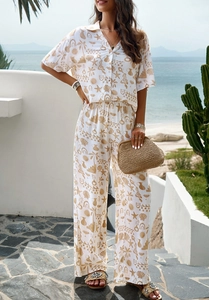 Detail of white short sleeve shirt and wide leg pants set with tropical starfish print