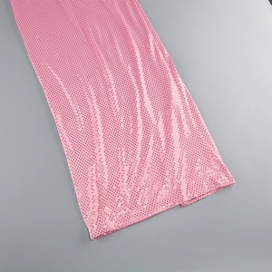 Detailed macro view of pink sequin fabric with shimmering texture and refined finish