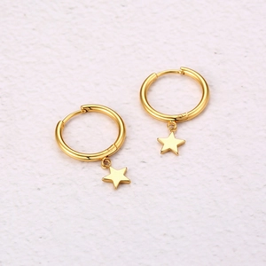 Close-up of golden stainless steel hoop earrings with hanging pentagram star pendants