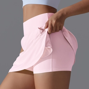 Detail of pink high-waisted tennis skirt with built-in athletic shorts for women