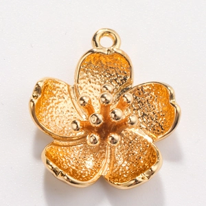 Detail of golden flower pendant with frosted petals and polished center for DIY jewelry