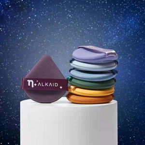 Macro detail of various colorful droplet-shaped makeup puffs on a starry background