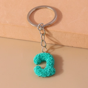 Detailed view of Tiffany blue resin rose petals on a C-letter shaped keychain