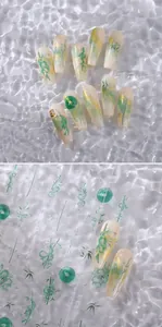 Detail of bamboo-themed nail stickers with green leaf patterns and golden accents
