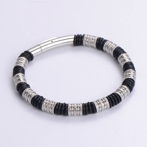 Detail of men's stainless steel bracelet showing textured rings and magnetic clasp