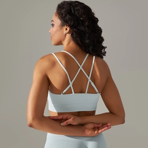 Detail of cross-back straps on seamless light grey blue yoga bra with ribbed texture