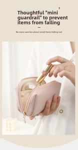 Detail of pink PU leather makeup bag with side guards to prevent items from falling out