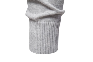 Close-up of the light gray ribbed cuff and fine knit texture on this men sweater