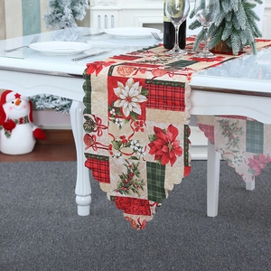 Christmas table runner with poinsettia and bell patterns for festive holiday dining decor