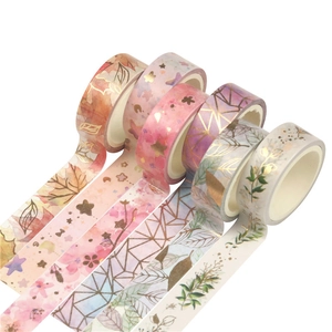 Five rolls of colorful bronzing washi tape with floral and geometric patterns
