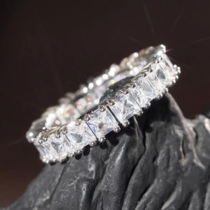Macro shot of princess cut cubic zirconia eternity band in silver plated setting