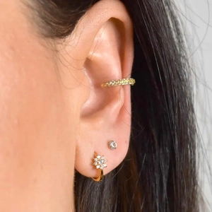 Elegant gold flower huggie earring with colorful zircon and cartilage ear cuff on model