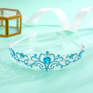 Detailed view of silver crown with blue rhinestones and elegant teal background
