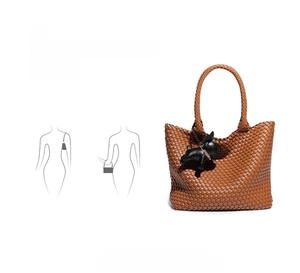 Detail of hand-woven brown tote bag showing versatile shoulder and hand-carry styles