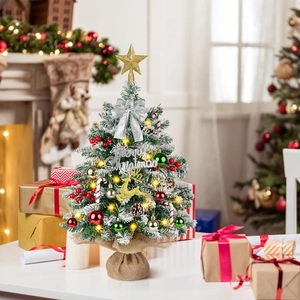 Close-up of a 55cm mini Christmas tree with LED lights and festive ornaments on a white table