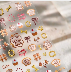 Close-up of cute dog nail art stickers with brown poodles and golden cake patterns