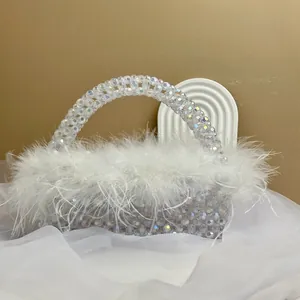Close-up of handmade beaded handbag with plush ostrich feathers and iridescent beads