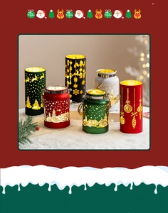 Detailed view of metal Christmas tea light holders with cutout reindeer and tree patterns