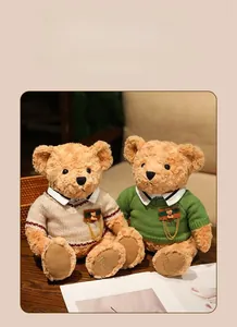 Close-up of plush teddy bears wearing knitted sweaters with badges and Teddy foot prints