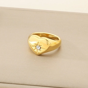 Detailed view of an 18K gold-plated heart ring featuring a centered sparkling starburst zircon