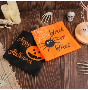 Detail view of orange and black Halloween candy bags with pumpkin and spider designs