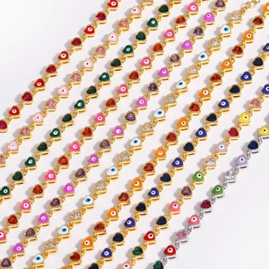 Detailed view of heart-shaped evil eye chain bracelets with colorful enamel inlay charms