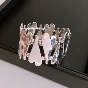 Silver heart link bracelet with textured hammered finish on high-elasticity band
