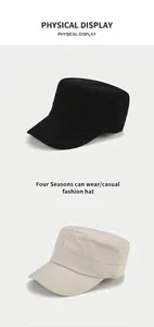 Detail of flat top army caps in black and beige showing canvas texture and stitching