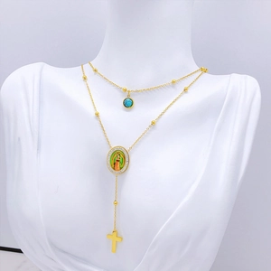 Golden layered necklace featuring turquoise stone, Virgin Mary medal, and cross pendant