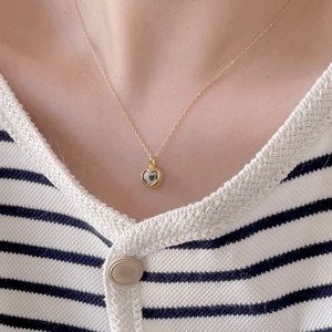 925 Sterling silver heart necklace with zebra stone pendant on striped knitwear