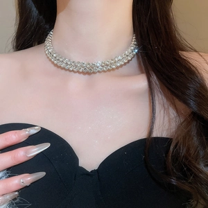 Close-up of a silver multilayer rhinestone choker necklace worn by a model