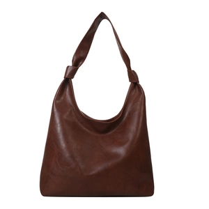 Deep brown vintage leather hobo bag with unique knotted strap on white background
