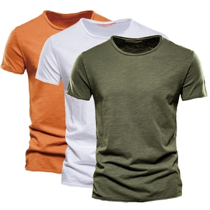 Folded men's slub cotton crewneck t-shirts in orange, white, and army green colors