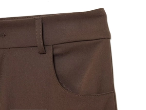 Detail of houndstooth pants waist showing belt loops and pocket in brown twill fabric
