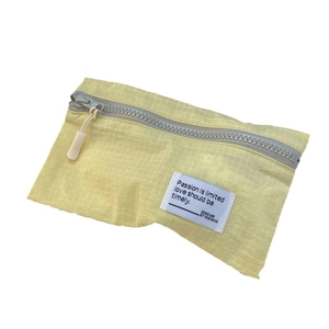Lightweight yellow plaid travel organizer bag with zipper and logo patch for suitcase packing