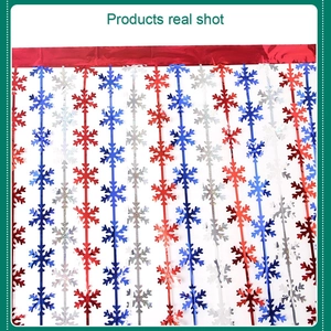 Detail of glittery red blue and silver snowflake fringe curtain for party wall decoration